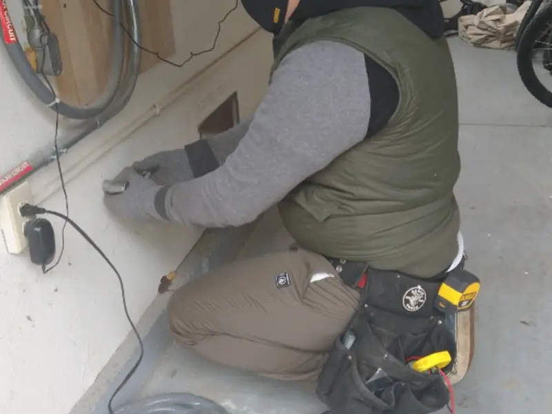 Electrician performing outlet wiring in a Morrilton garage